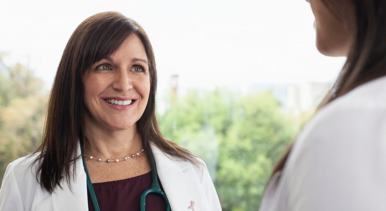 Smiling female doctor --- Image by © Samantha Mitchell/Corbis