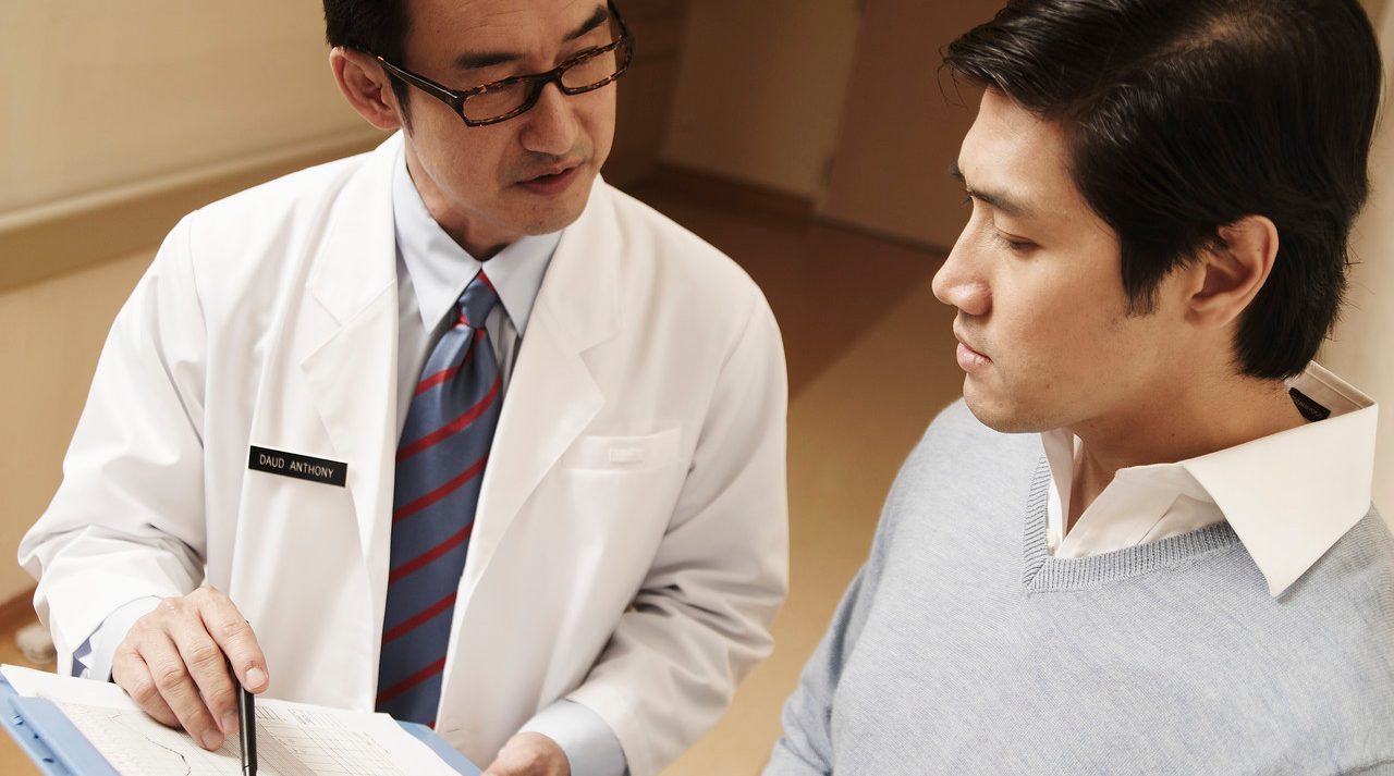 Doctor Talking with Patient --- Image by © Milk Photographie/Corbis