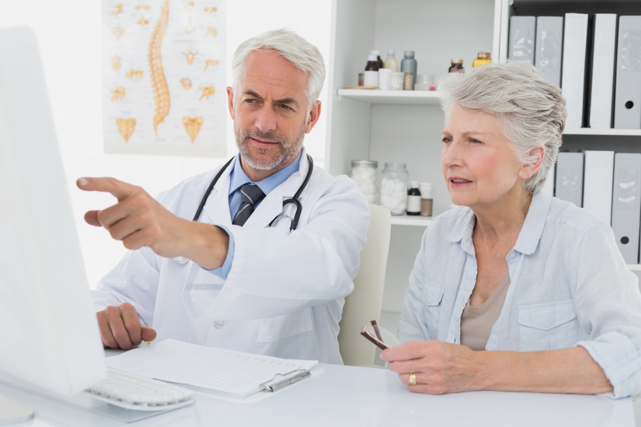 22 Nov 2013 --- Doctor with female patient reading reports on computer --- Image by © Wavebreak Media LTD/Wavebreak Media Ltd./Corbis