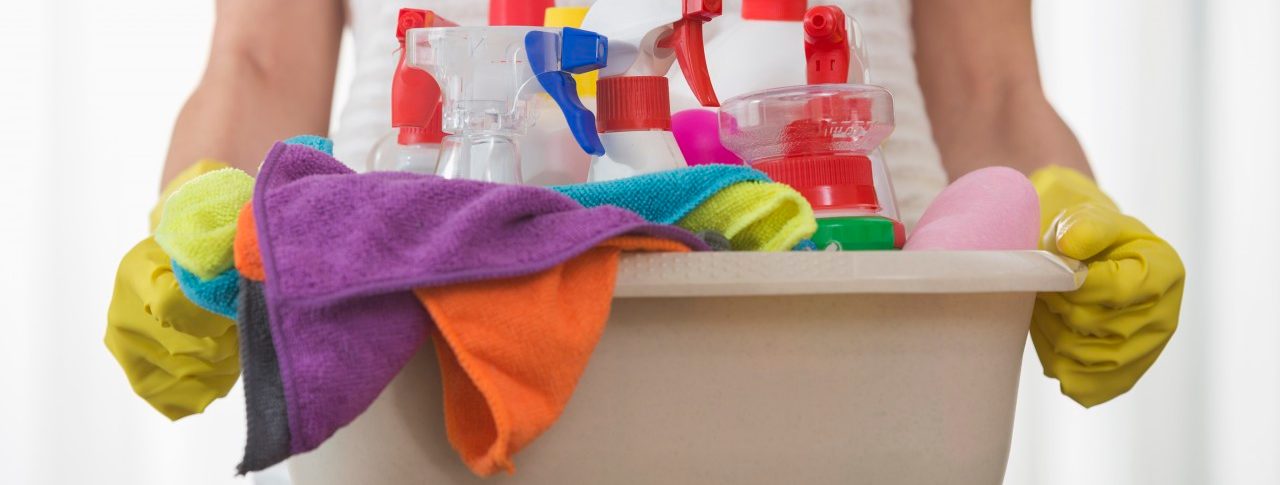 Midsection of woman carrying basket of cleaning supplies --- Image by © Agnieszka Wozniak/moodboard/Corbis