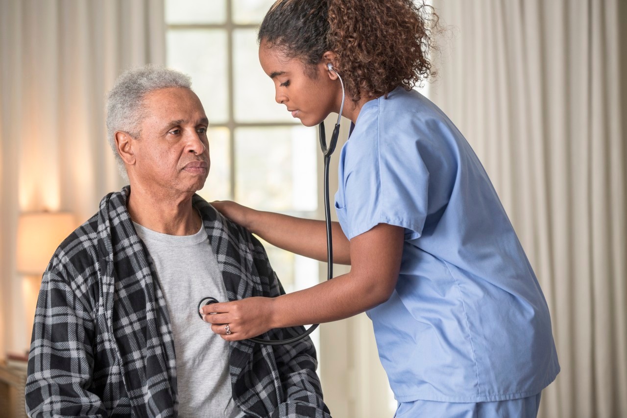 12 Dec 2013 --- African American nurse listening to Senior patient's heartbeat --- Image by © Terry Vine/Blend Images/Corbis