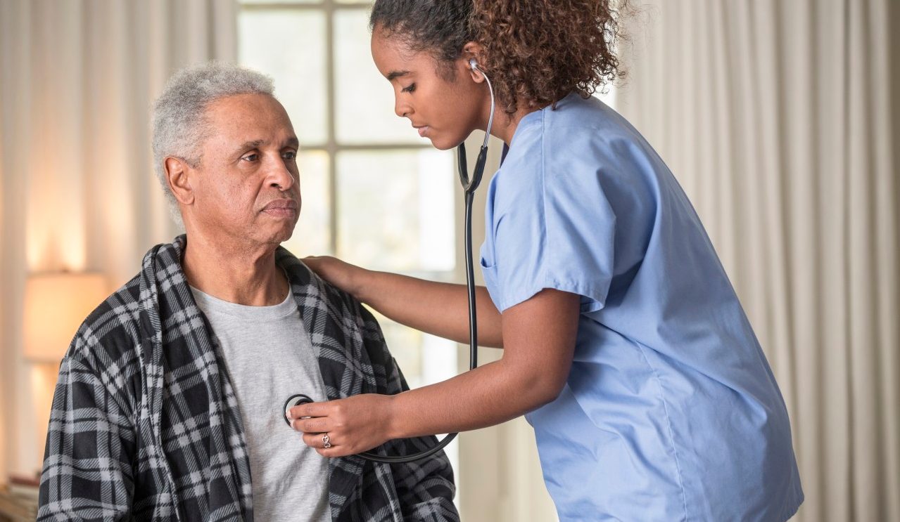 12 Dec 2013 --- African American nurse listening to Senior patient's heartbeat --- Image by © Terry Vine/Blend Images/Corbis