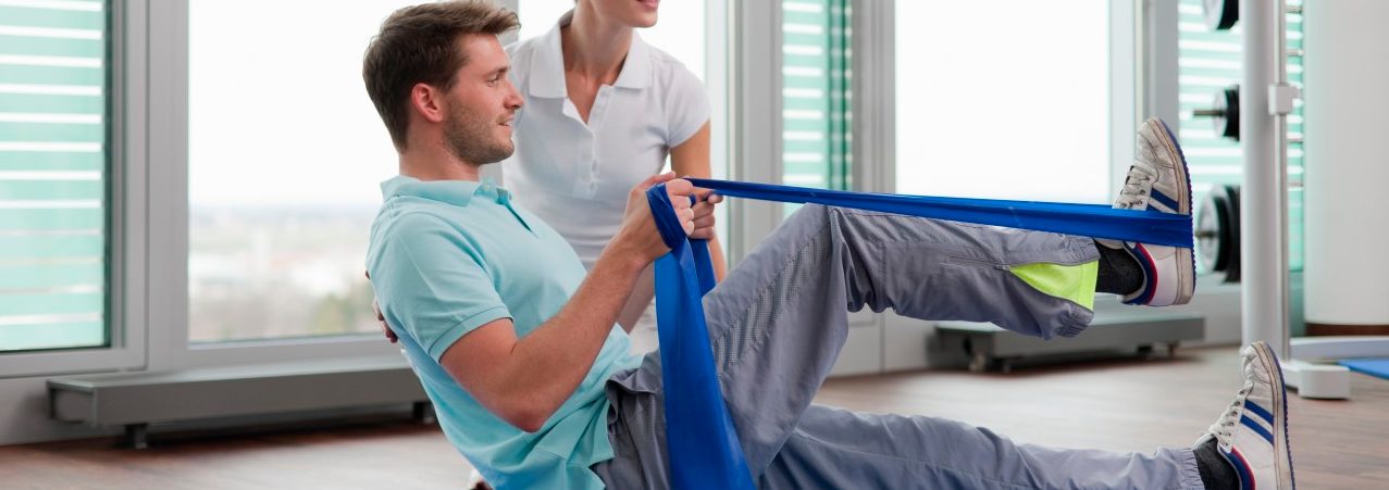 14 Mar 2012 --- Trainer working with man in gym --- Image by © Henglein and Steets/cultura/Corbis