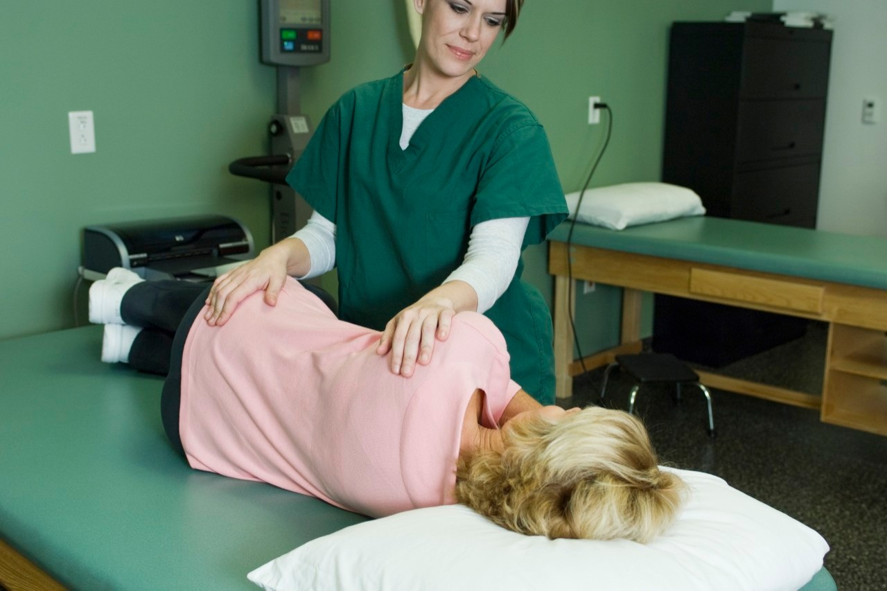 Woman being treated by physical therapist --- Image by © Michele Constantini/PhotoAlto/Corbis