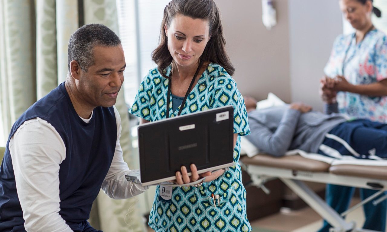 Therapist talking with patient --- Image by © Isaac Lane Koval/Corbis