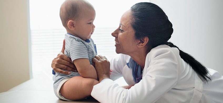 Pediatrician with baby girl (2-5 months) --- Image by Â© Hiya Images/Corbis