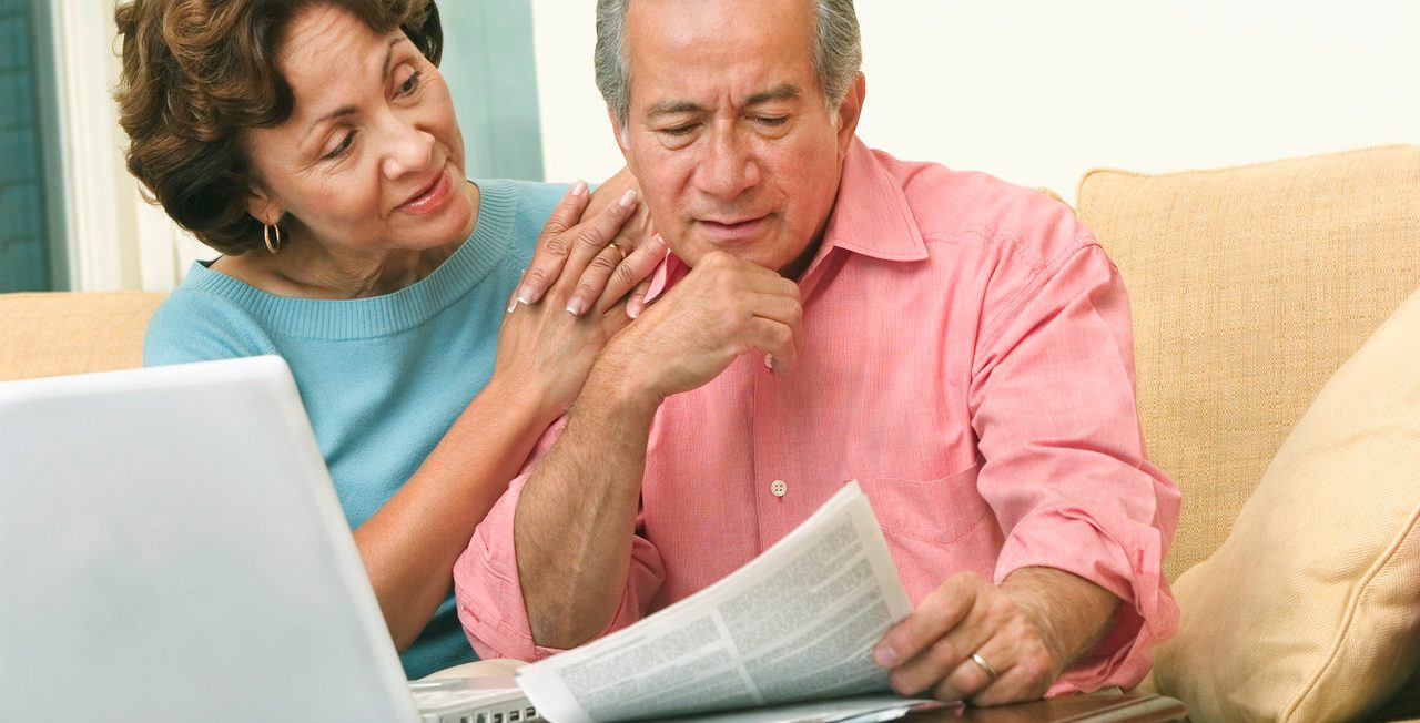 Couple Doing Paperwork with Laptop --- Image by © Tom & Dee Ann McCarthy/CORBIS