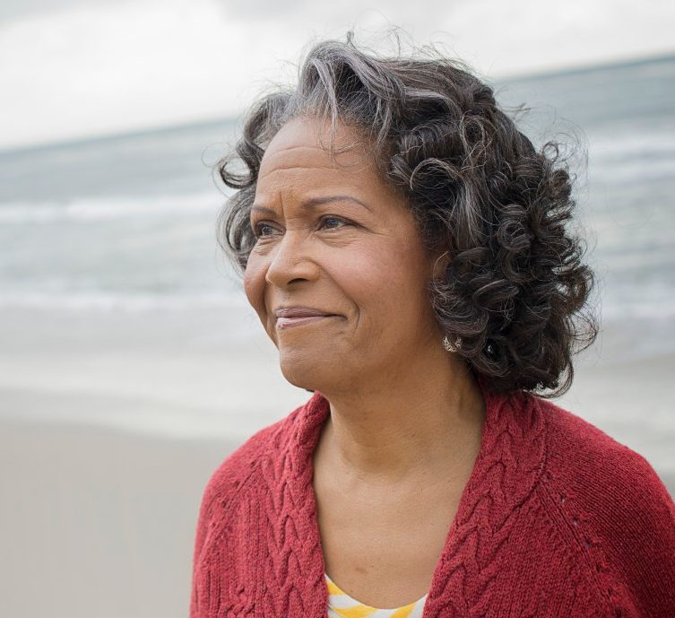 Portrait of elderly woman on beach --- Image by © Hiya Images/Corbis