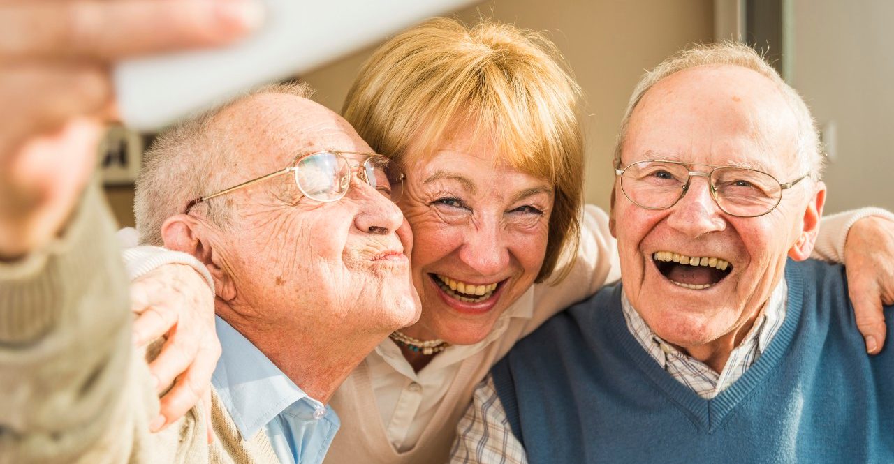 13 Feb 2015 --- Cheerful seniors taking selfie --- Image by © Uwe Umstätter/Westend61/Corbis