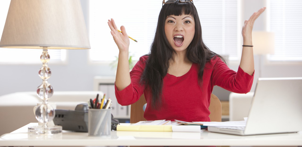 01 Oct 2010 --- Angry Asian woman throwing papers in home office --- Image by © Hill Street Studios/Blend Images/Corbis