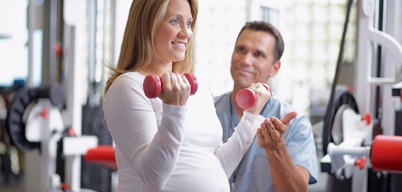 Physical Therapist with Pregnant Woman Patient --- Image by © Sean Justice/Corbis