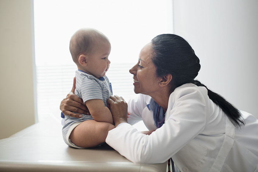 Pediatrician with baby girl (2-5 months) --- Image by Â© Hiya Images/Corbis