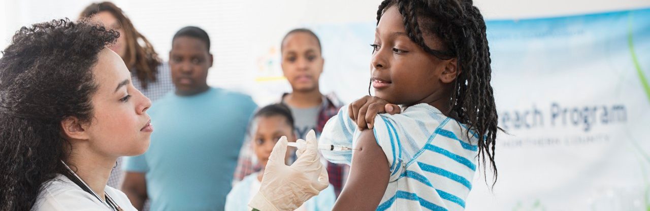 Girl (8-9) being vaccinated --- Image by © Jose Luis Pelaez/Corbis