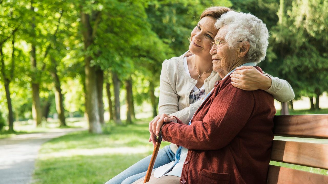 22 May 2014 --- Senior woman sitting on park bench with granddaughter --- Image by © Uwe Umstaetter/Cultura/Corbis