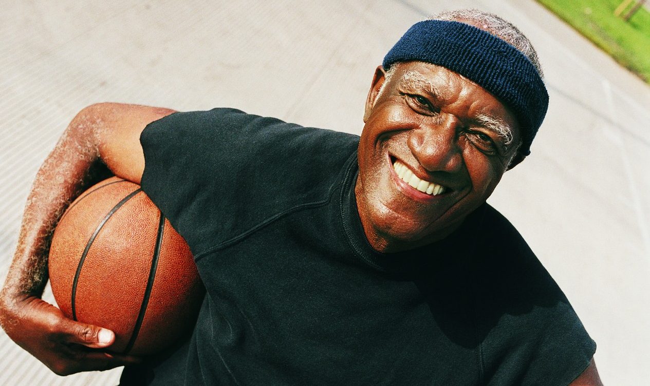 Elevated View of an Elderly Man Standing Holding a Basketball --- Image by © 2/Ocean/Corbis