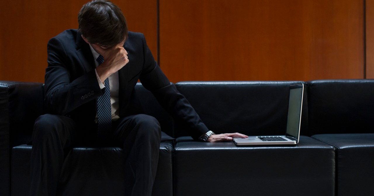 15 Feb 2014 --- Businessman covering eyes with hand in disbelief --- Image by © Frederic Cirou/PhotoAlto/Corbis