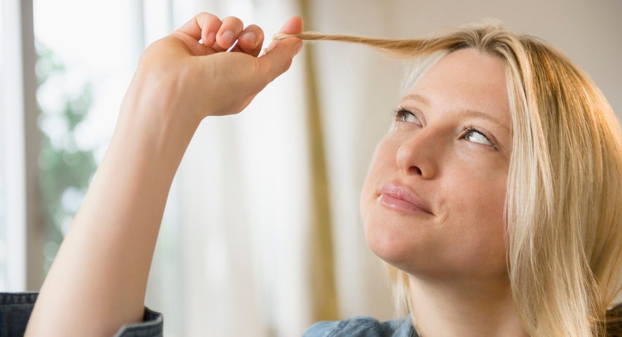 07 Nov 2014 --- Woman twisting her hair --- Image by © Jamie Grill/Tetra Images/Corbis