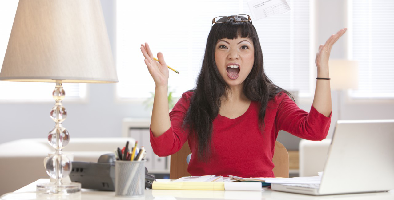 01 Oct 2010 --- Angry Asian woman throwing papers in home office --- Image by © Hill Street Studios/Blend Images/Corbis