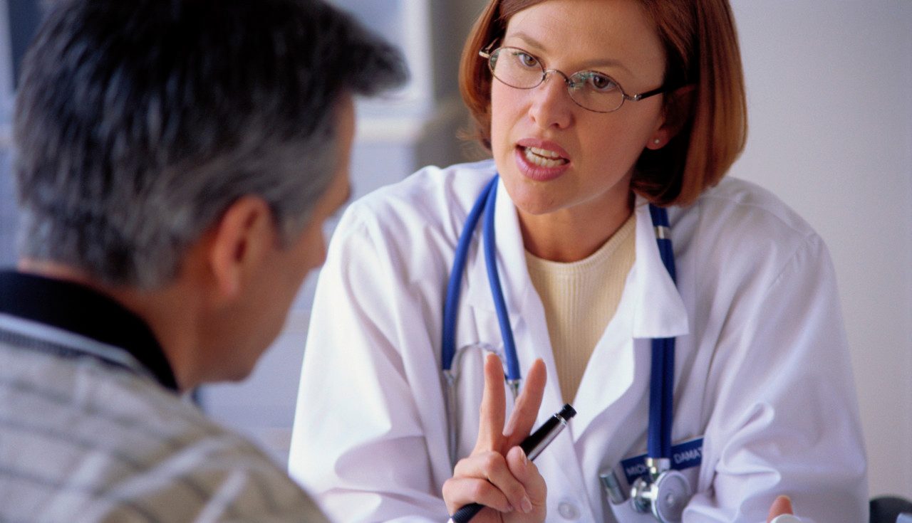 Physician Consulting Patient --- Image by © Stephen Welstead/LWA/Corbis