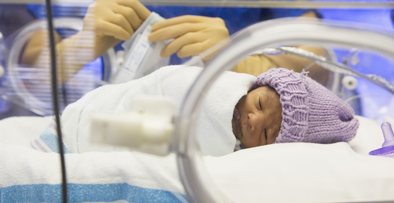 Premature Baby in Incubator --- Image by © Corbis