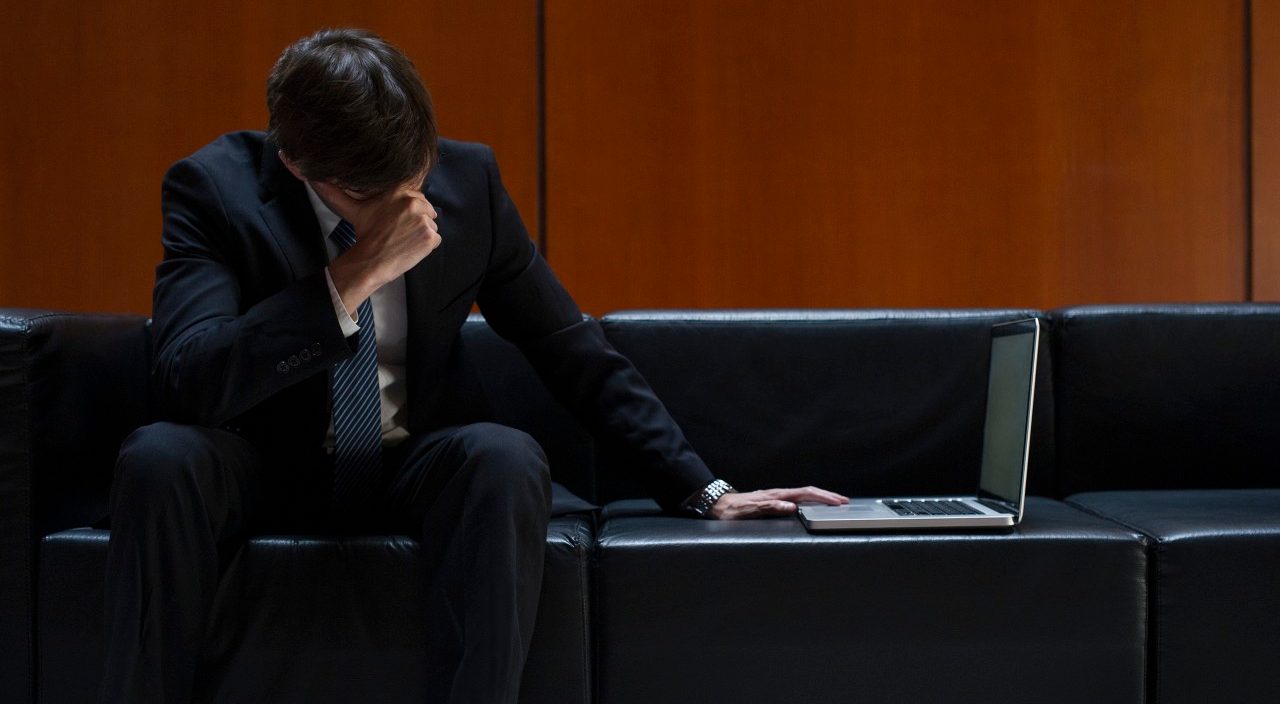 15 Feb 2014 --- Businessman covering eyes with hand in disbelief --- Image by © Frederic Cirou/PhotoAlto/Corbis