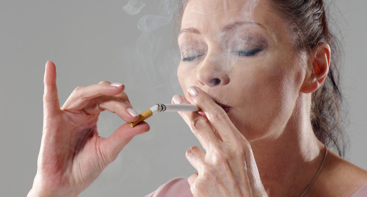 Woman Chain Smoking --- Image by © Wolf/Corbis