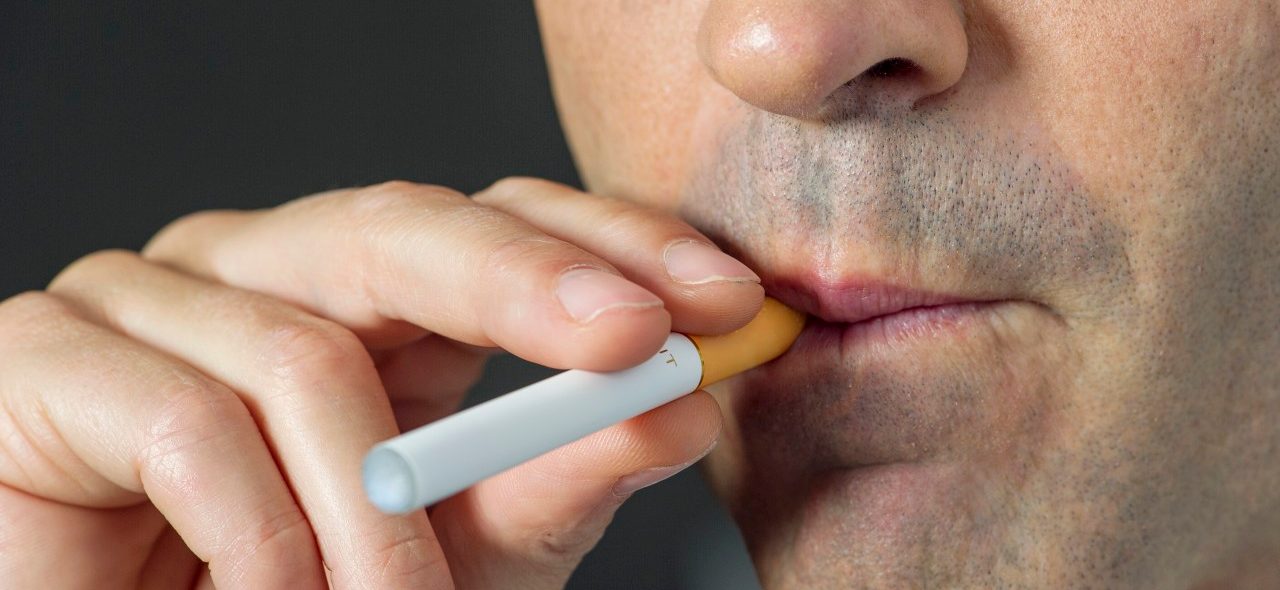 22 Oct 2013 --- Man smoking electonic cigarette, cropped --- Image by © Frederic Cirou/PhotoAlto/Corbis