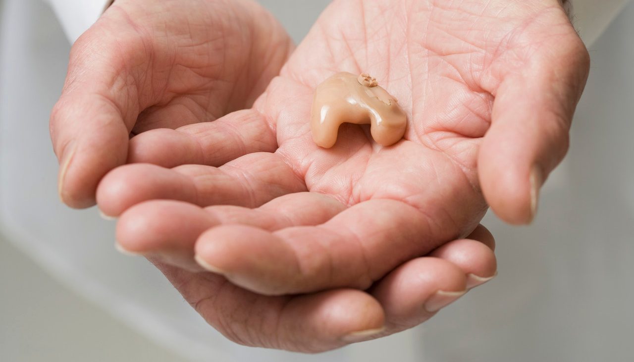 Close up of senior Hispanic man's hearing aid --- Image by © Jose Luis Pelaez, Inc./Blend Images/Corbis