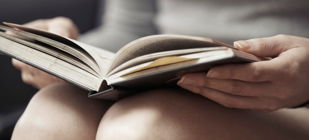 15 Mar 2014 --- Hands of woman reading book at home --- Image by © Arman Zhenikeyev/Corbis