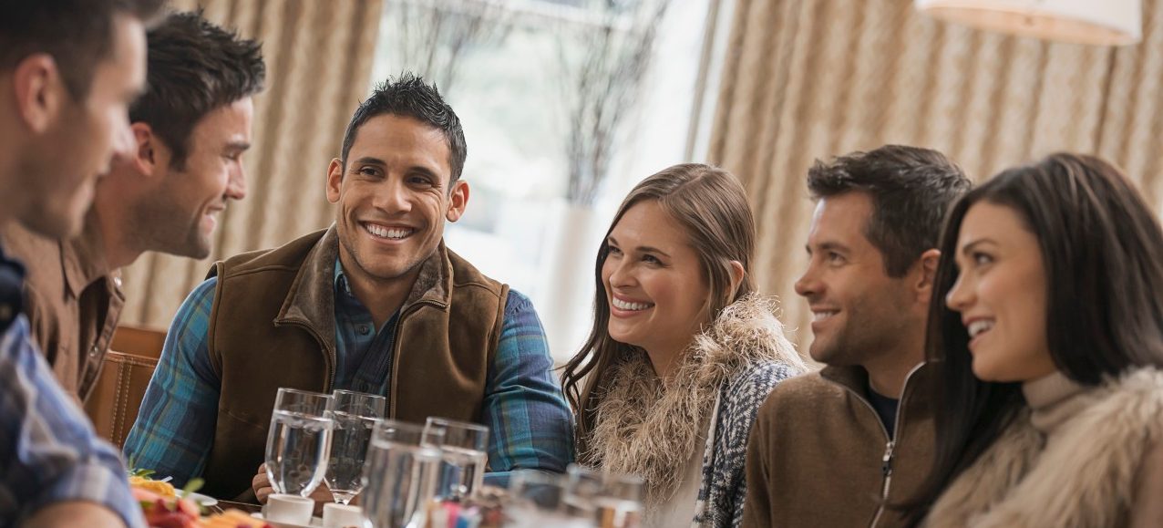 Group of friends having dinner at restaurant --- Image by © Hiya Images/Corbis