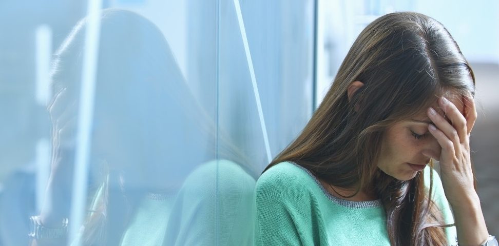 25 Apr 2014 --- Mid adult businesswoman leaning against glass wall in office with hand on face --- Image by Â© Ghislain & Marie David de Lossy/Corbis