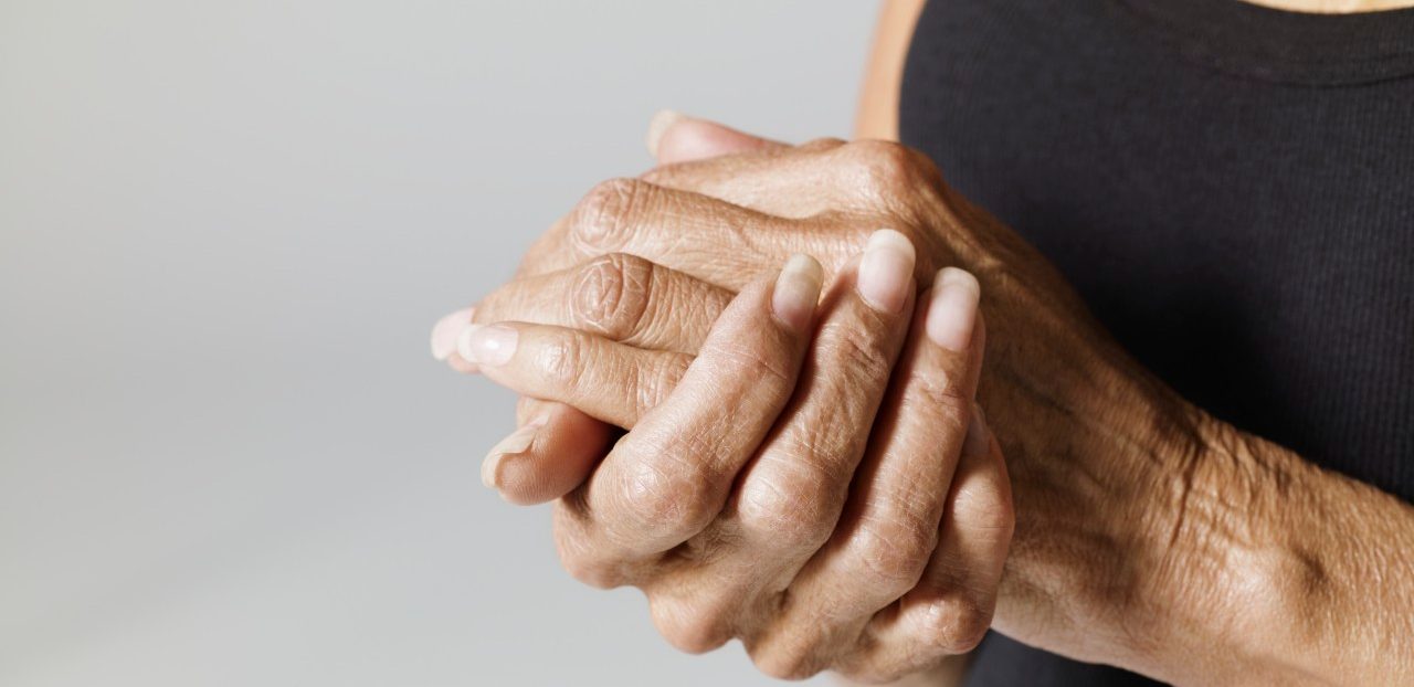 Woman with hands together --- Image by © Mark Weiss/Corbis