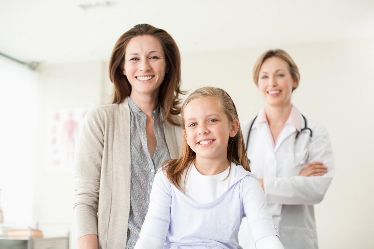 Doctor, mother and daughter in doctorÃ ?s office