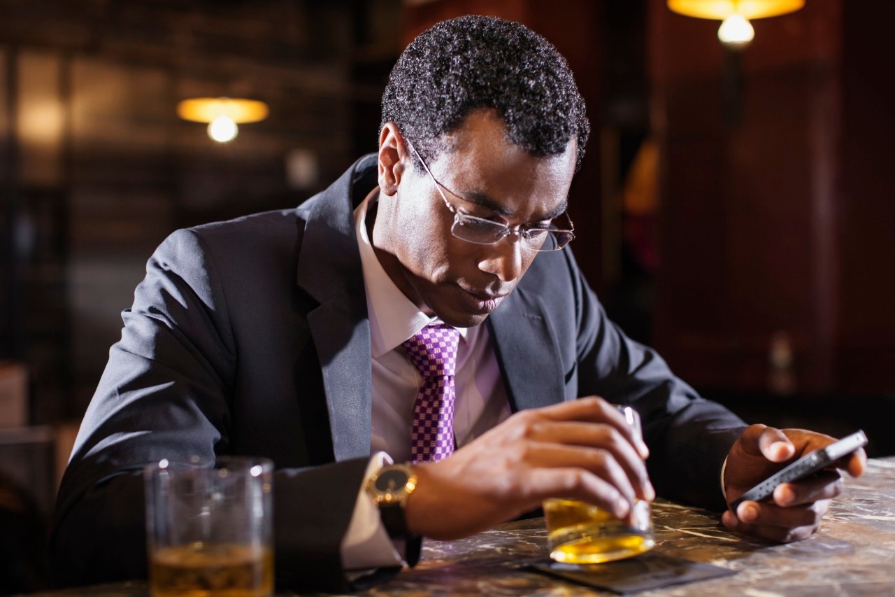 Businessman sitting at bar counter --- Image by © Sonja Pacho/Corbis