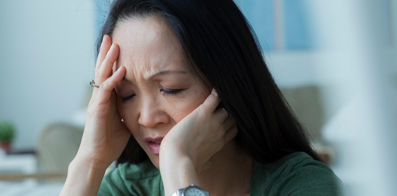 Mature woman with head in hands --- Image by © Rob Lewine/Corbis