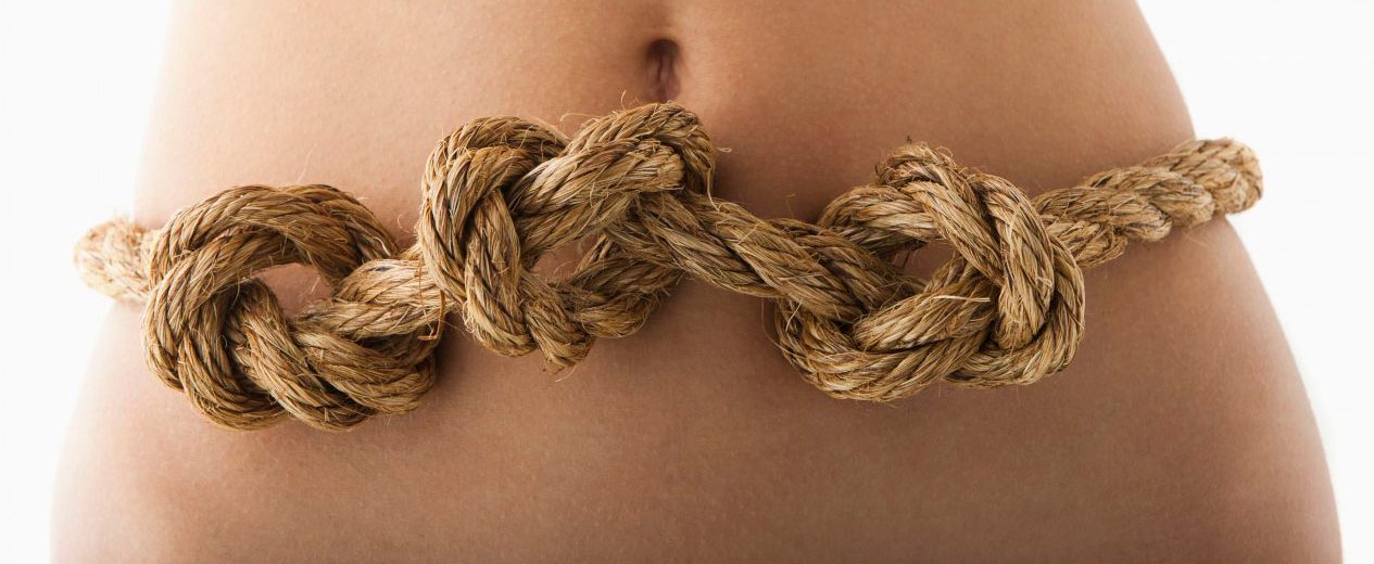 Young woman with knots in stomach --- Image by Â© Mike Kemp/Tetra Images/Corbis