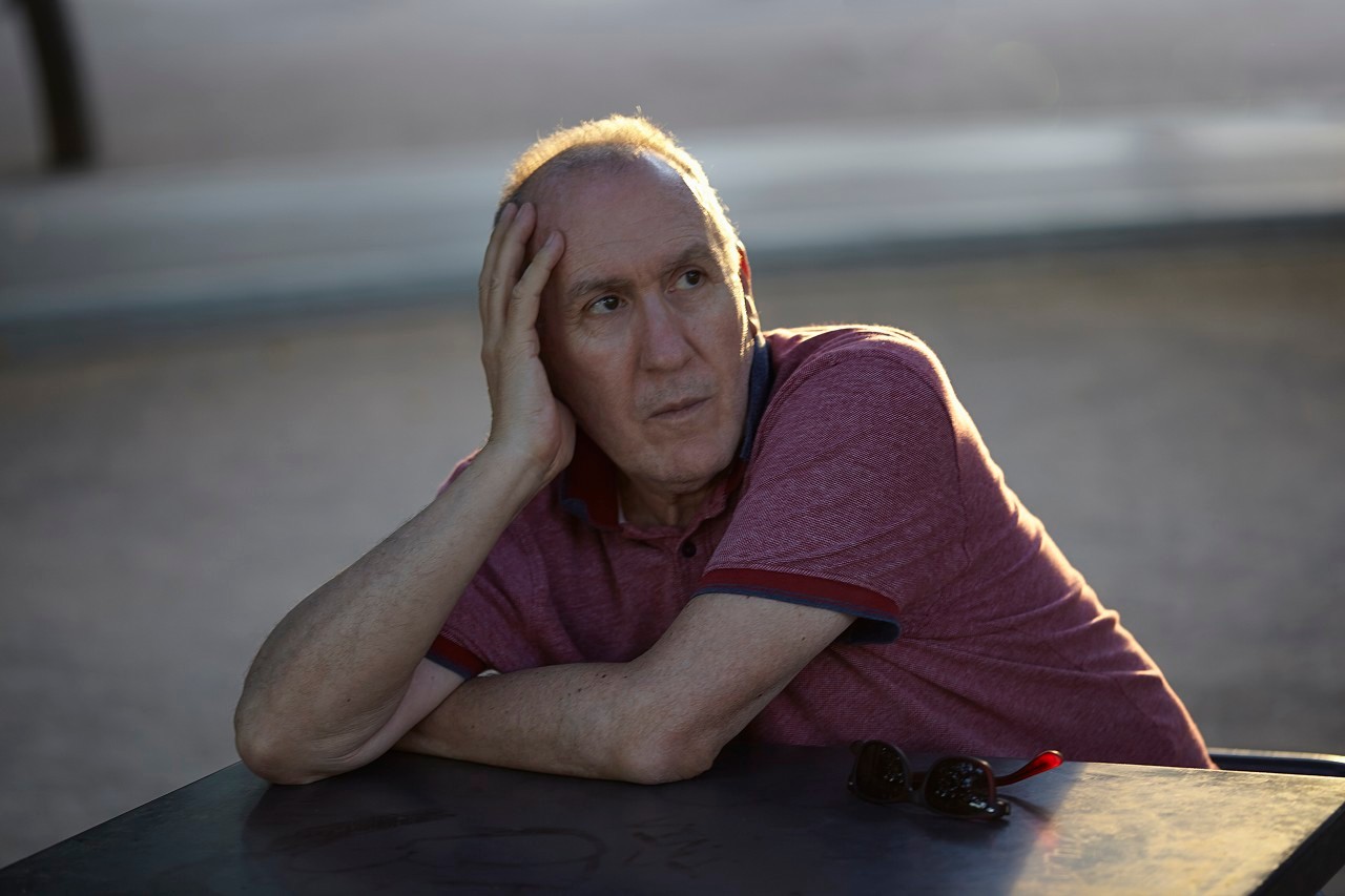 01 Jan 2000 --- Senior man sitting at table, resting on elbow --- Image by © Aleli Dezmen/Corbis