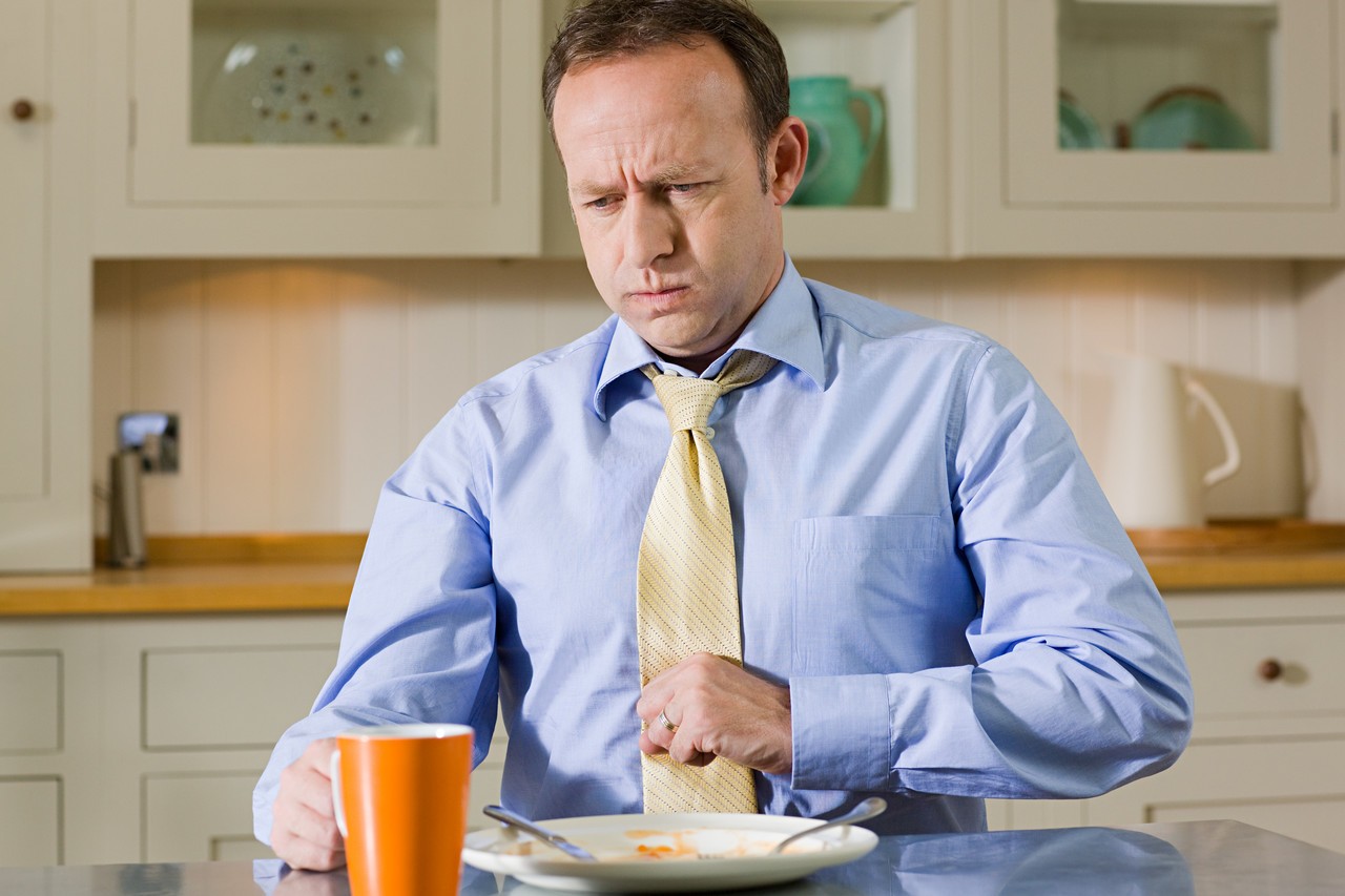 Man with indigestion --- Image by © 13/Image Source/Ocean/Corbis