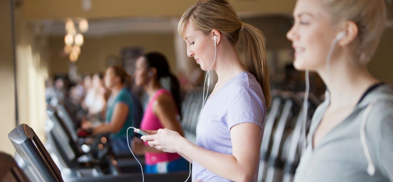 11 May 2012 --- Caucasian women using mp3 players on treadmills in gym --- Image by © Jose Luis Pelaez Inc/Blend Images/Corbis