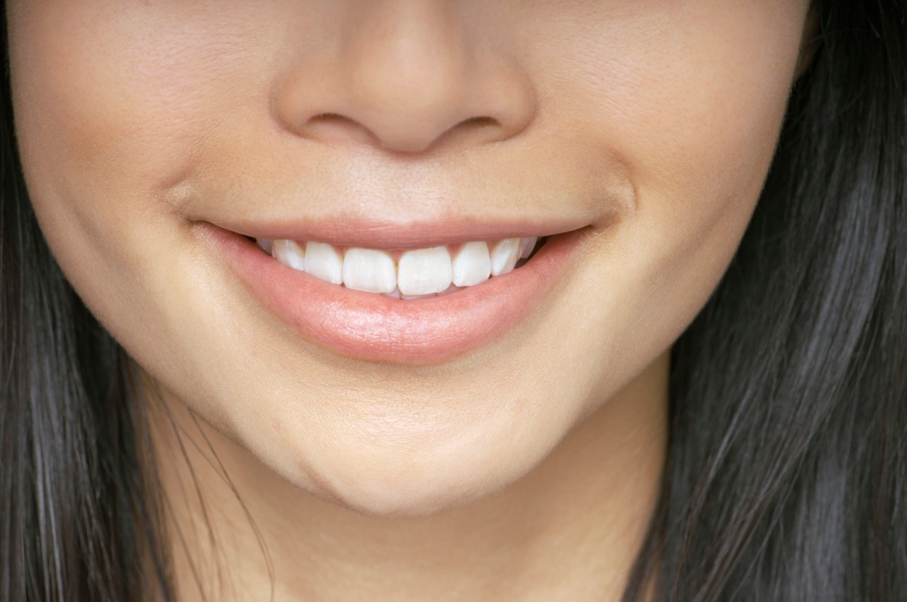 Woman smiling --- Image by © Beau Lark/Corbis