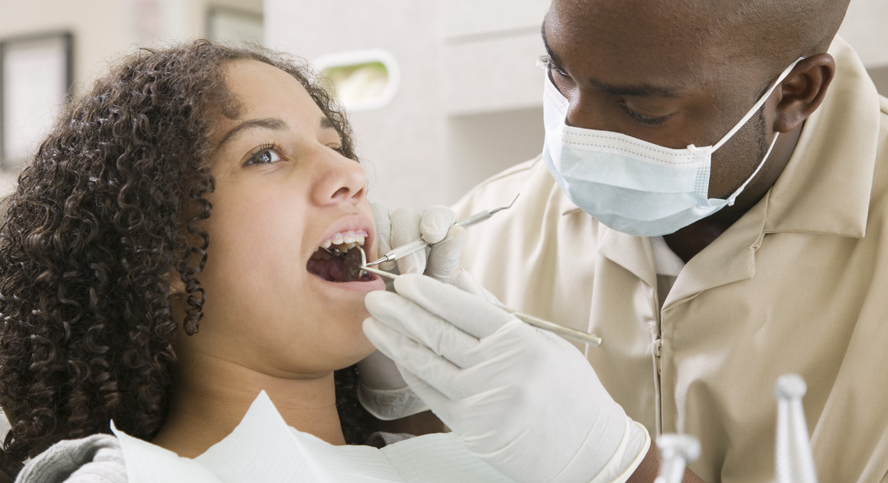 Dentist with Patient --- Image by © Lucidio Studio, Inc./Corbis