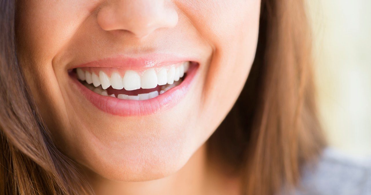 01 May 2014 --- Close up of woman's smile --- Image by © JGI/Jamie Grill/Blend Images/Corbis