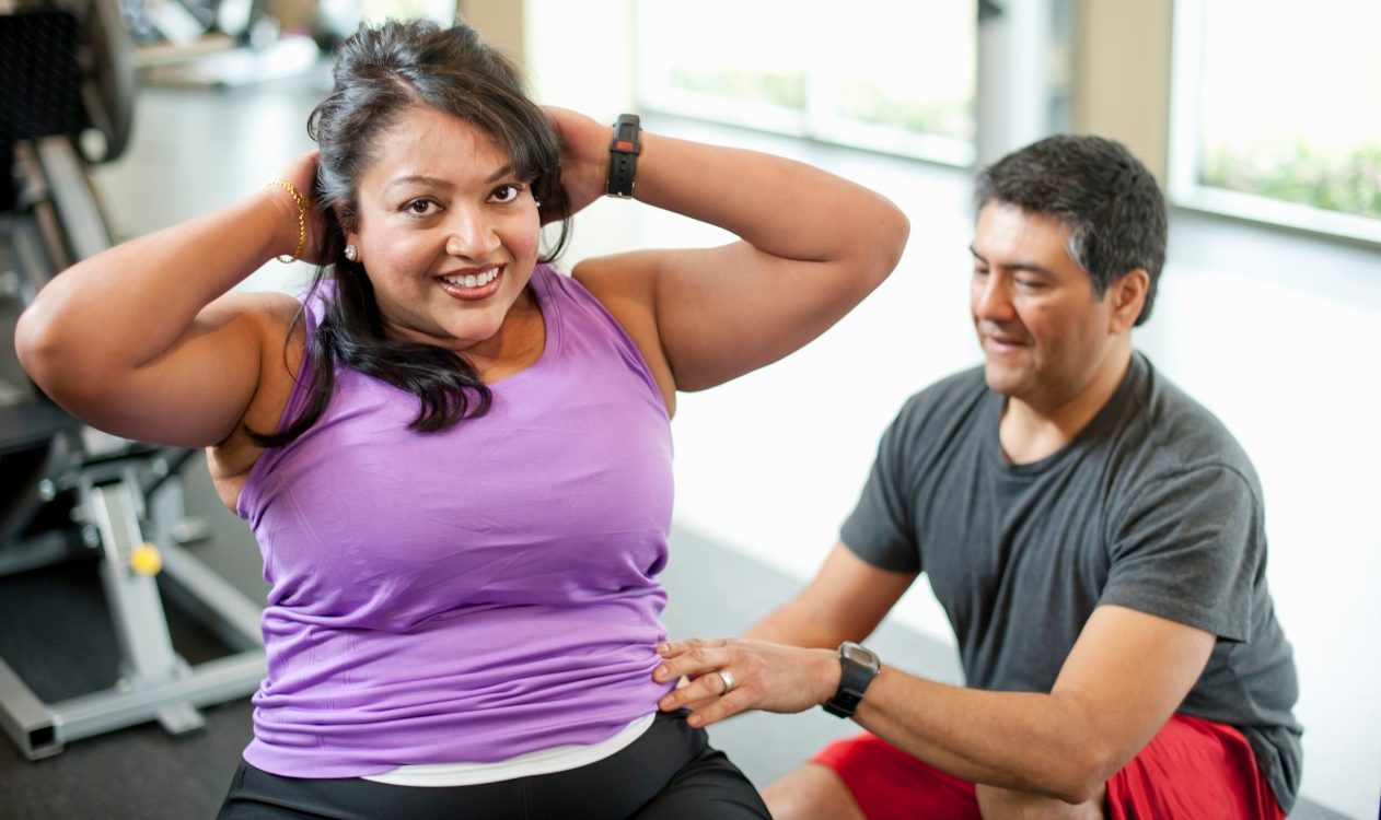 14 Mar 2012 --- Woman working with trainer in gym --- Image by © yellowdog/cultura/Corbis