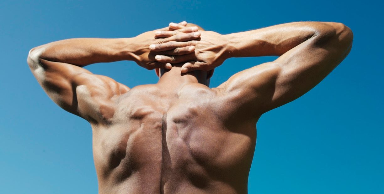 Muscular man with hands behind head --- Image by © Bernd Vogel/Corbis