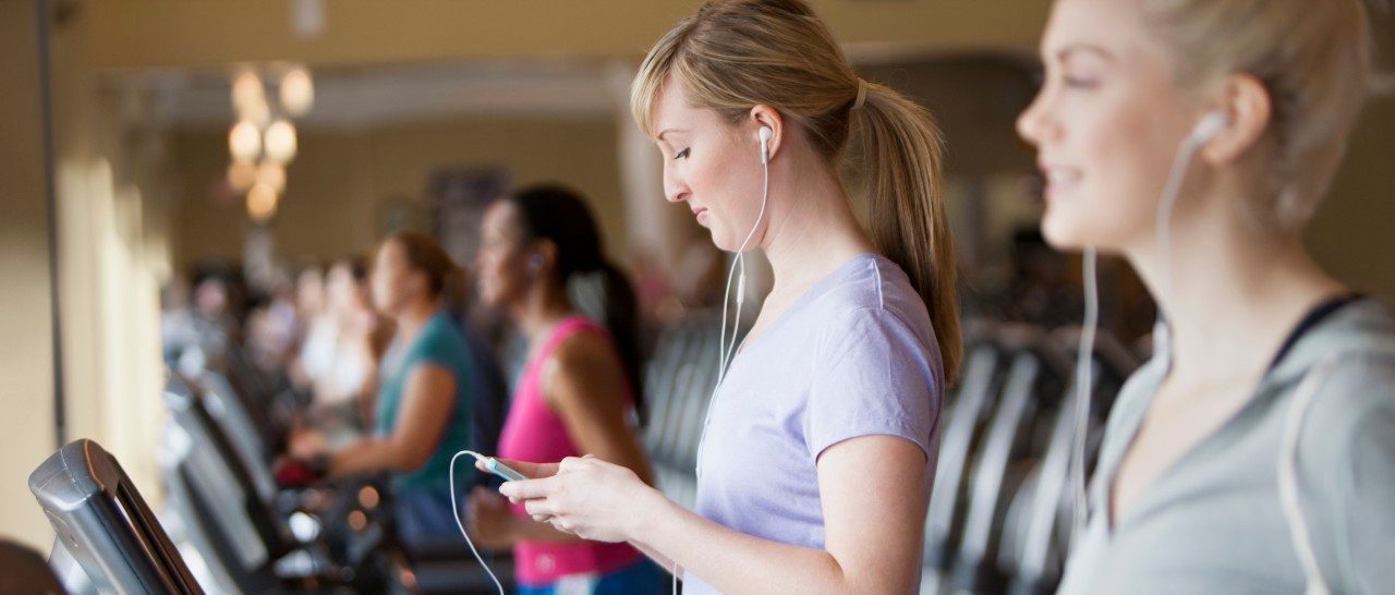 11 May 2012 --- Caucasian women using mp3 players on treadmills in gym --- Image by © Jose Luis Pelaez Inc/Blend Images/Corbis