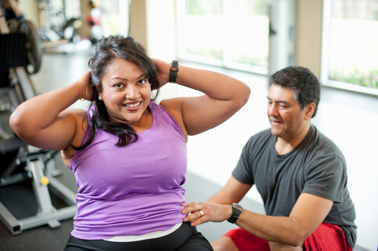 14 Mar 2012 --- Woman working with trainer in gym --- Image by © yellowdog/cultura/Corbis