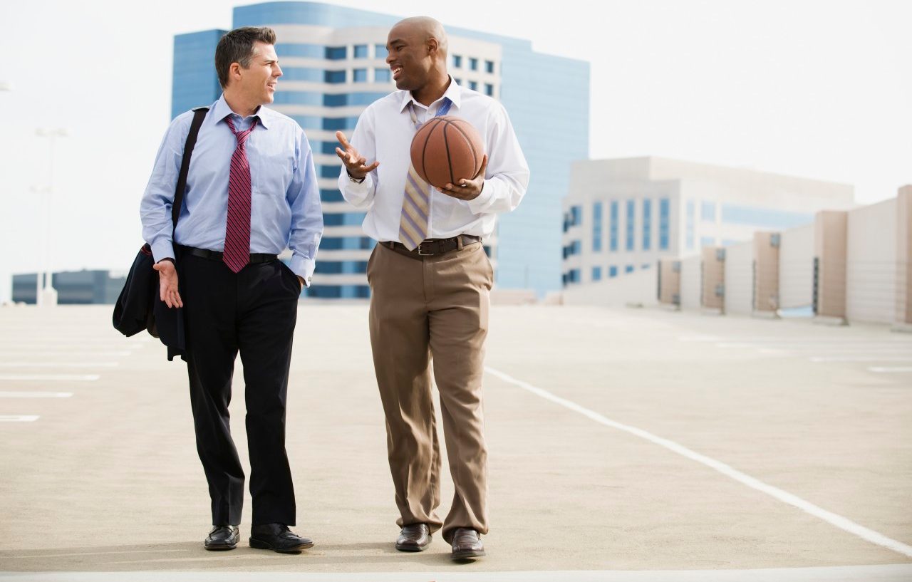 Businessman on their way to basketball game --- Image by © Erik Isakson/Tetra Images/Corbis