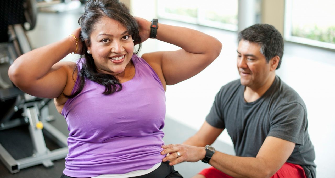 14 Mar 2012 --- Woman working with trainer in gym --- Image by © yellowdog/cultura/Corbis