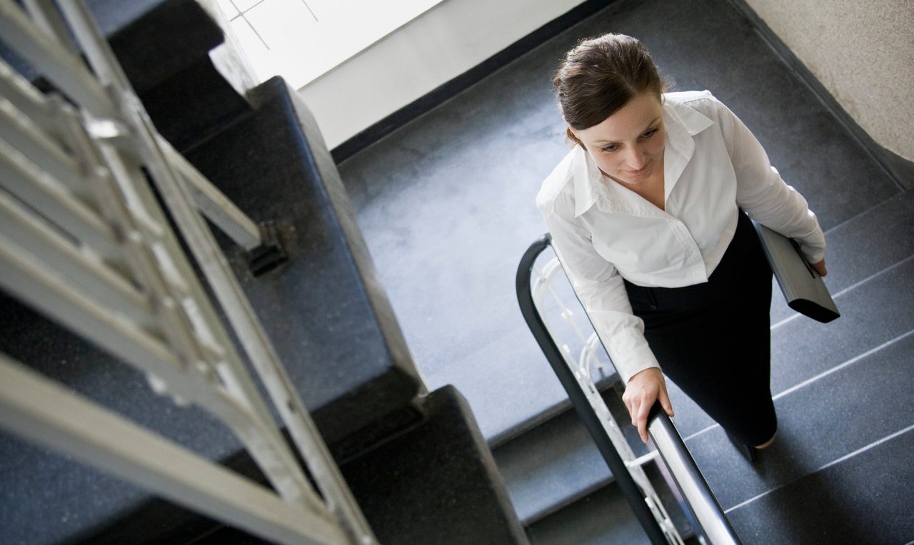 Woman walking up stairs --- Image by © Andersen Ross/cultura/Corbis