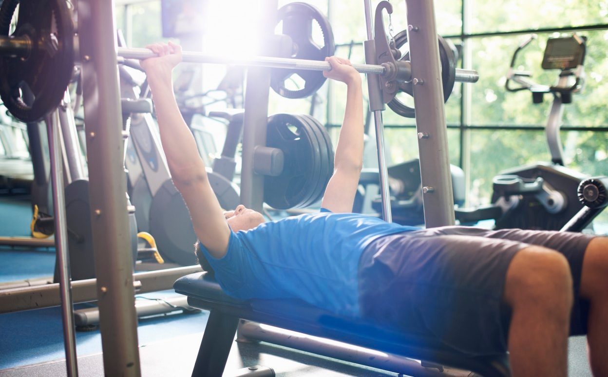 02 Jul 2014 --- Young man weight lifting with barbell --- Image by © Peter Muller/Corbis